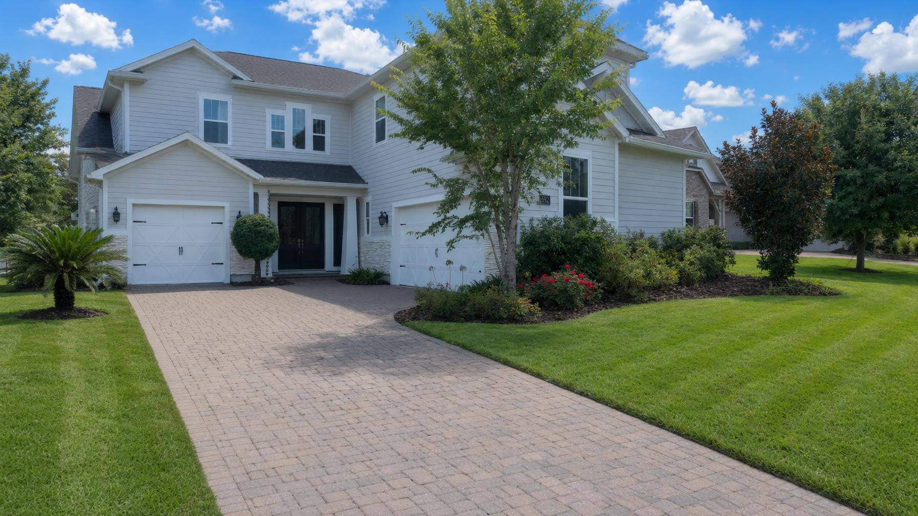 Manicured striped lawn and landscaped beds in front of a Florida home